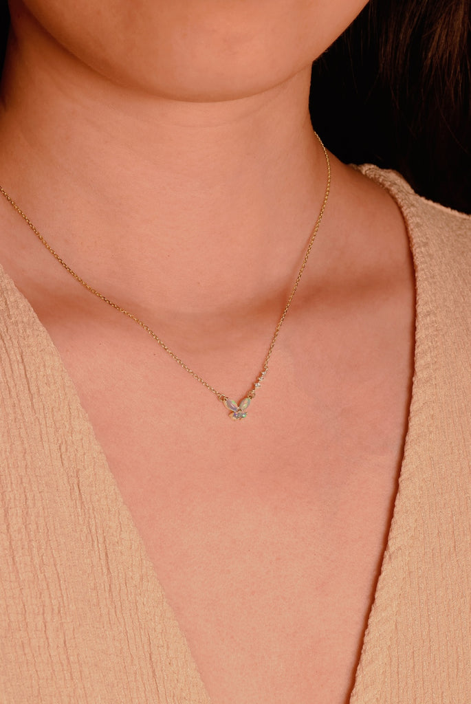 Model Wearing a Butterfly Opal Necklace with Diamonds in Yellow Gold