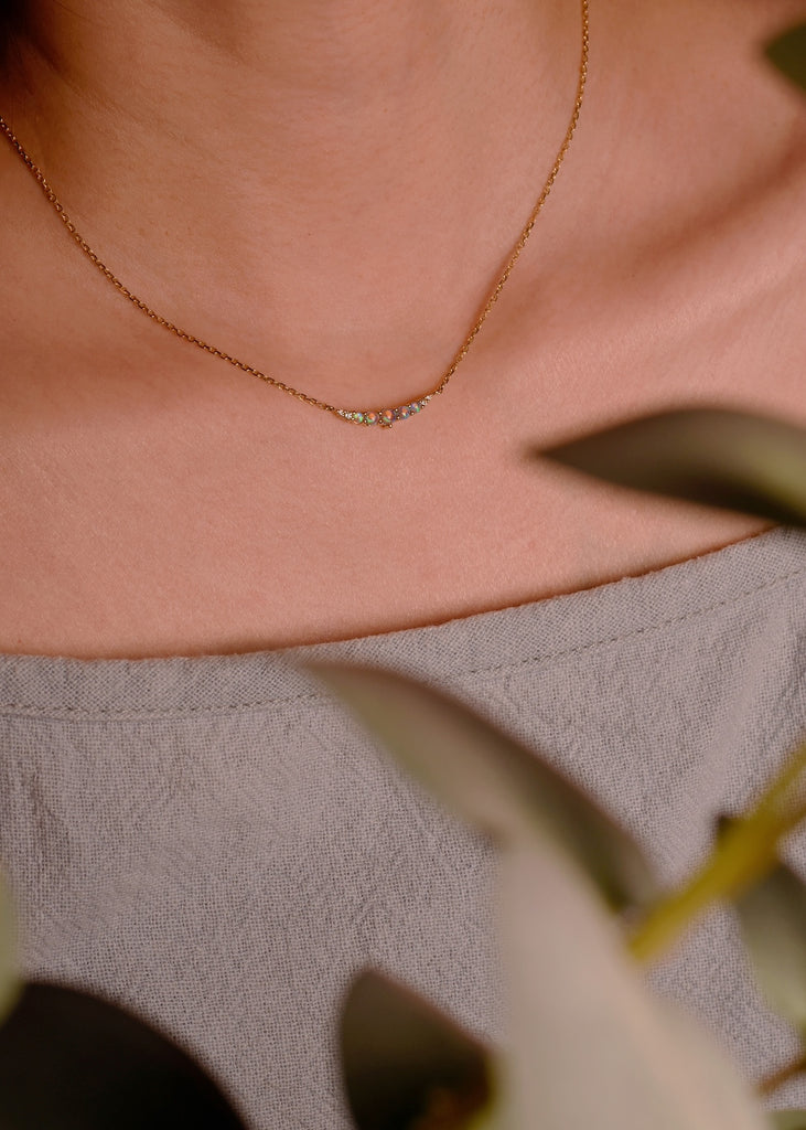 Model Wearing a Smile Blue Green Opal Necklace with Diamonds in Yellow Gold
