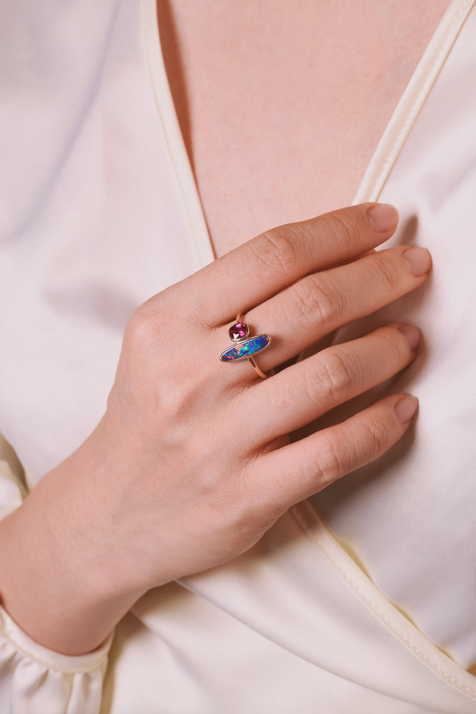Model wearing Emberia Opal Ring with Ruby in Rose Gold
