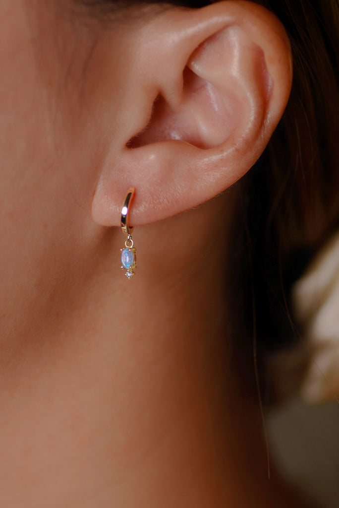 Model wearing Grace Opal Hoop Earrings with Diamonds in Yellow Gold