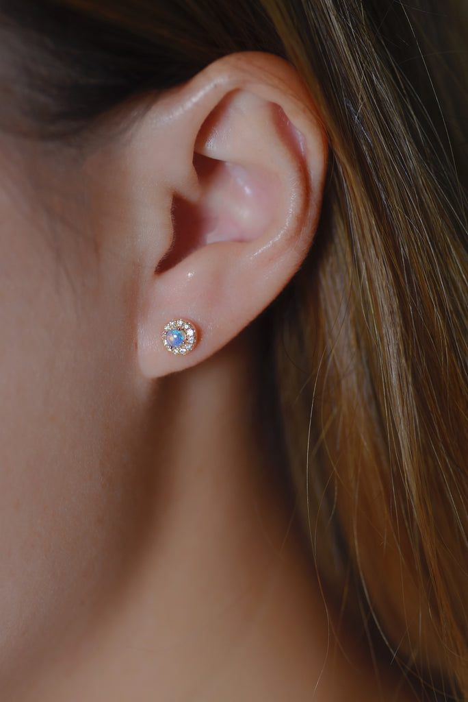 Model wearing Halo Opal Earrings with Diamonds in White Gold, Blue
