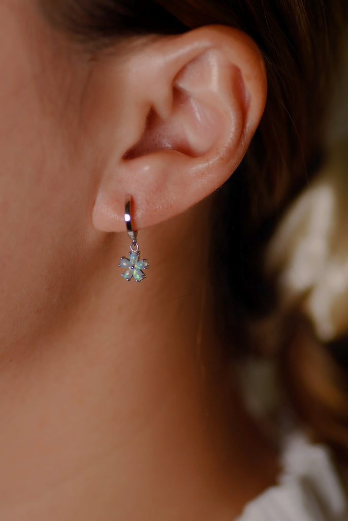 Model wearing Hana Opal Huggie Earrings in White Gold