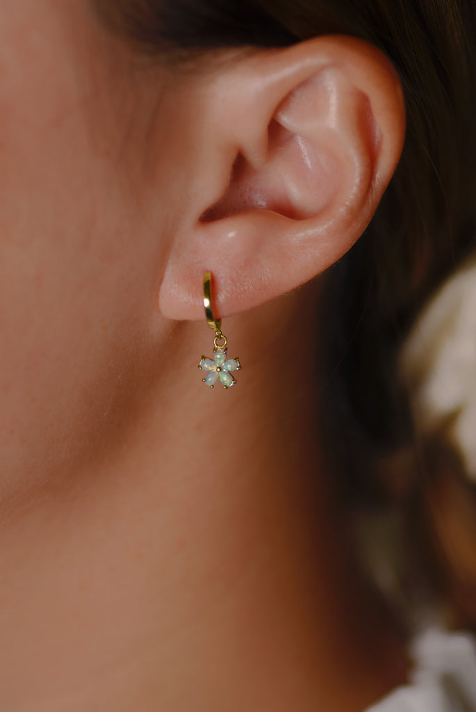 Model wearing Hana Opal Huggie Earrings in Yellow Gold