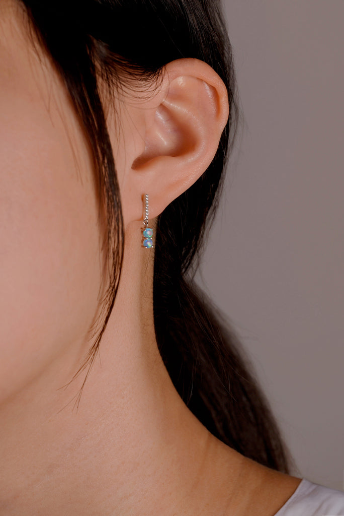 Model wearing Magic Wand Opal Earrings with Diamonds in White Gold
