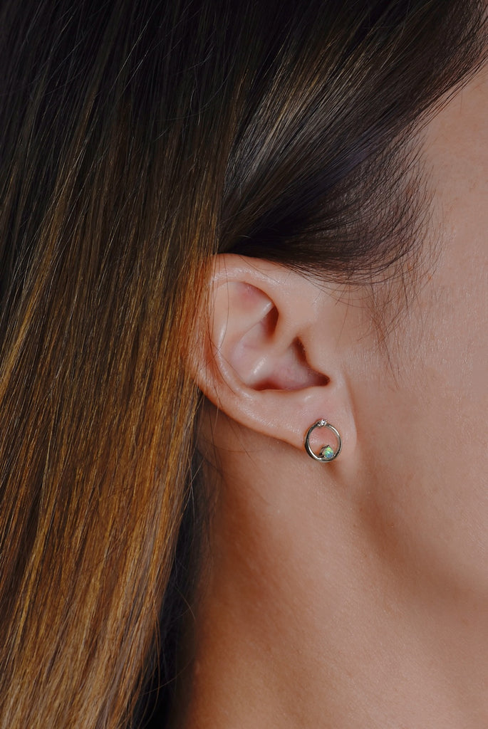 Model wearing Orbit Opal Stud Earrings with Diamonds in White Gold