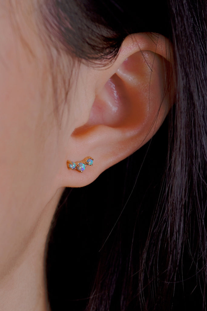Model wearing Orion's Belt Opal Stud Earrings in Yellow Gold
