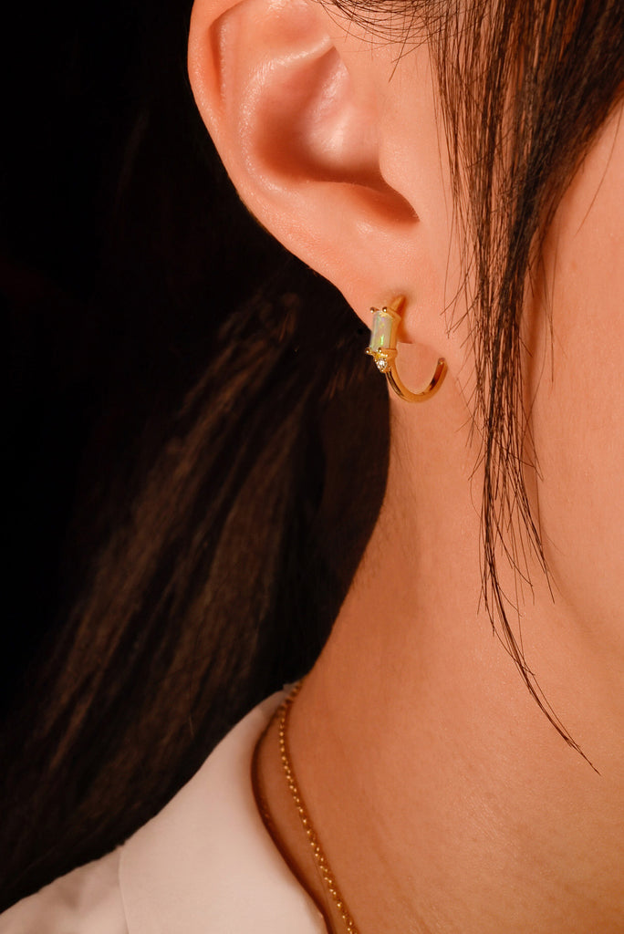 Model wearing Rectangle Opal Hoop Earrings with Diamonds in Yellow Gold