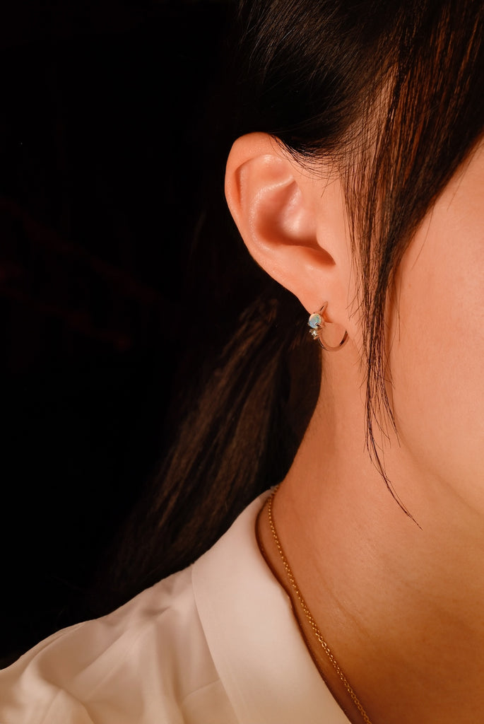 Model wearing Round Opal Hoop Earrings with Diamonds in White Gold