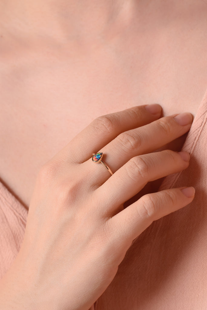 Model wearing Teardrop Opal Ring in Yellow Gold, Red Doublet
