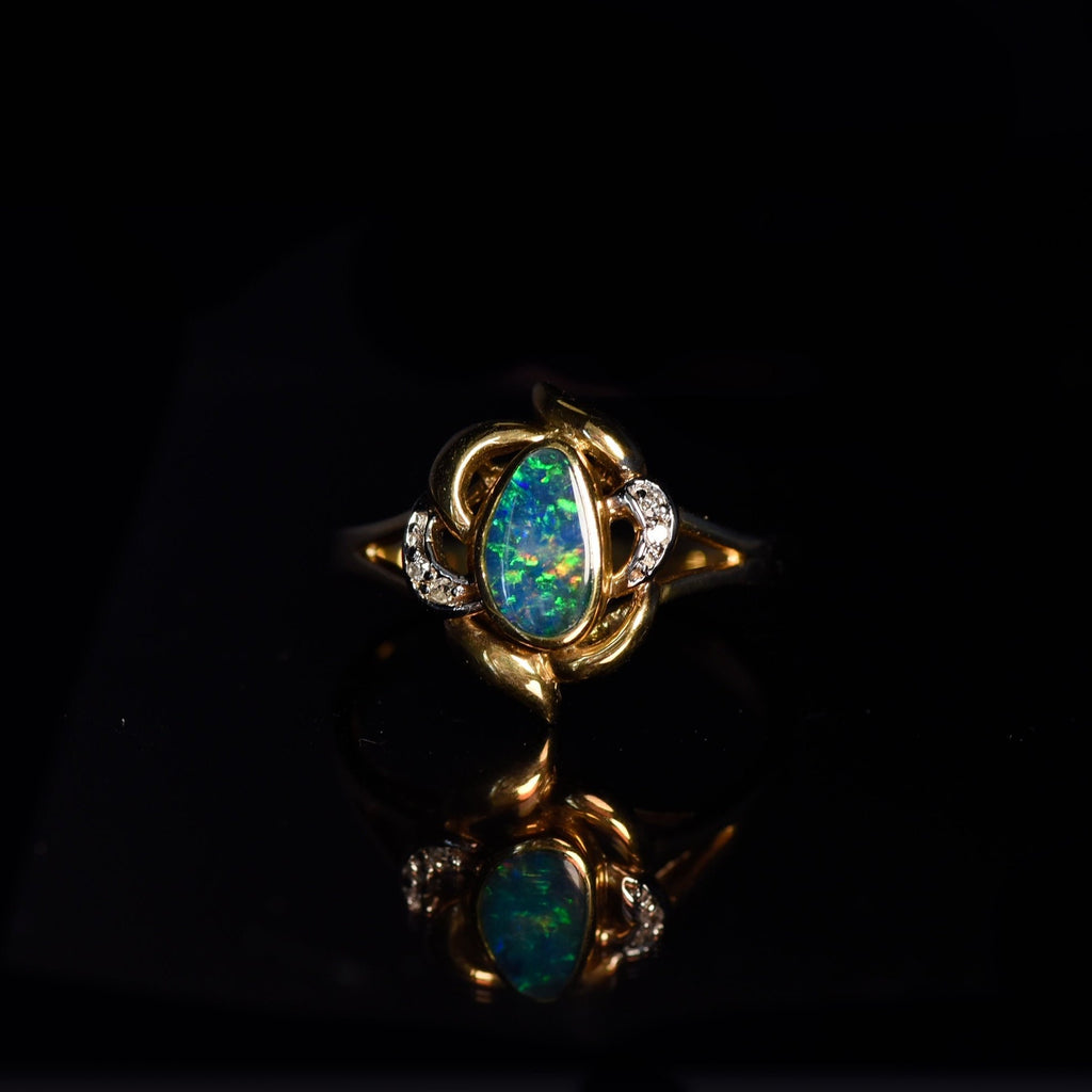 Ribbon Opal Vintage Ring with Diamonds in Yellow Gold on dark background
