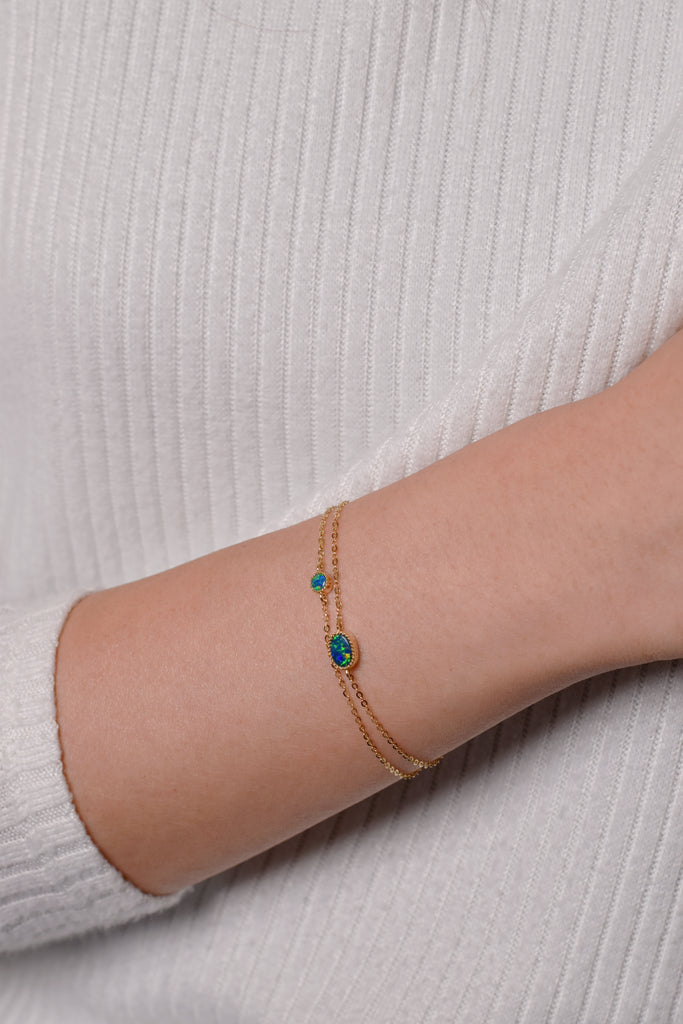 Round and Oval Doublet Opal Bracelets in Yellow Gold on wrist