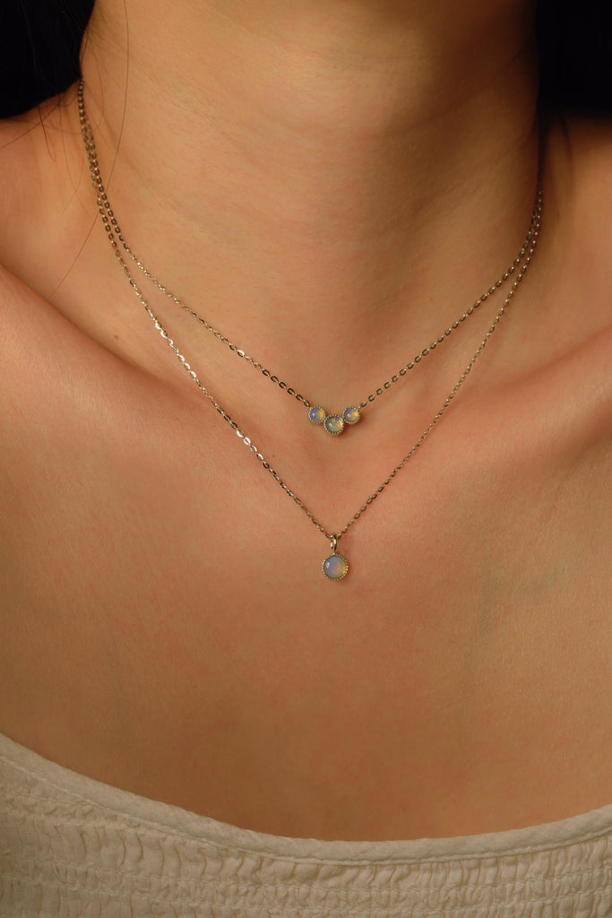 Model wearing Bliss Blue Opal Necklaces in Sterling Silver, Single and Three Stones