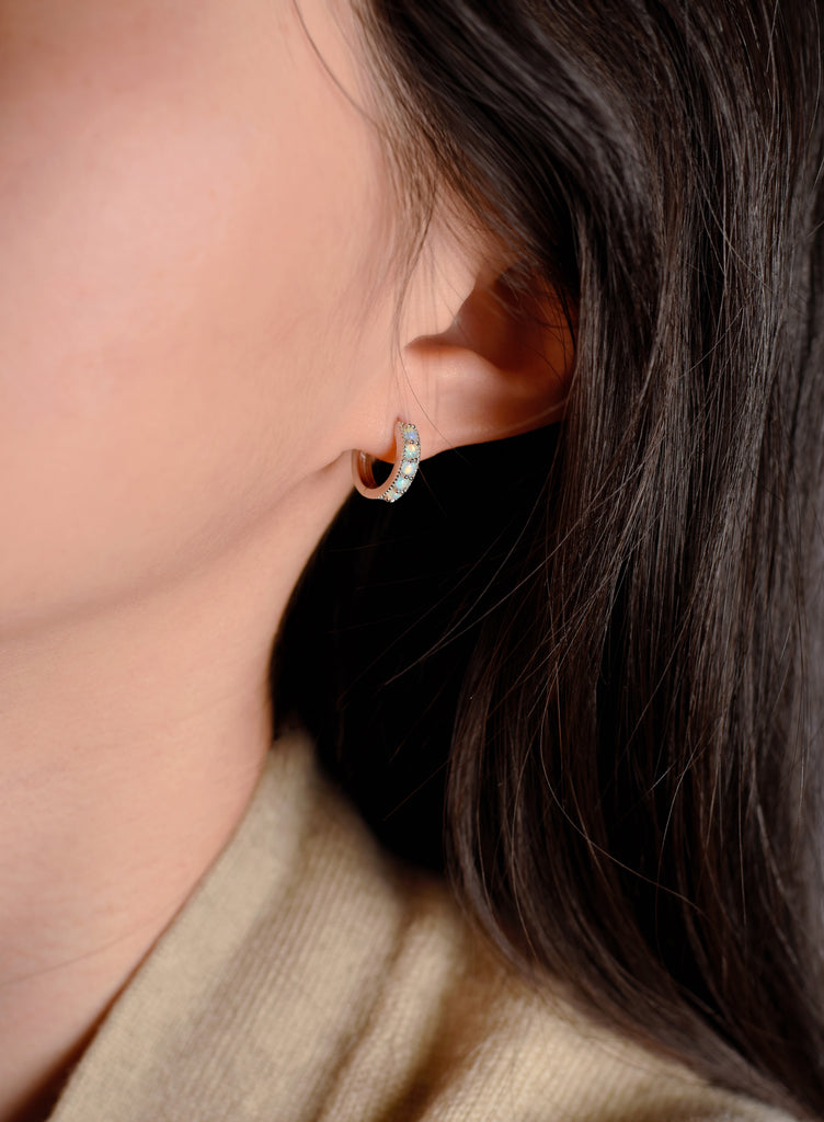 Model wearing Bliss Opal Hoop Earrings in Sterling Silver, Blue