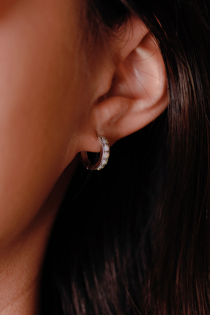 Model wearing Bliss Opal Hoop Earrings in Sterling Silver, White