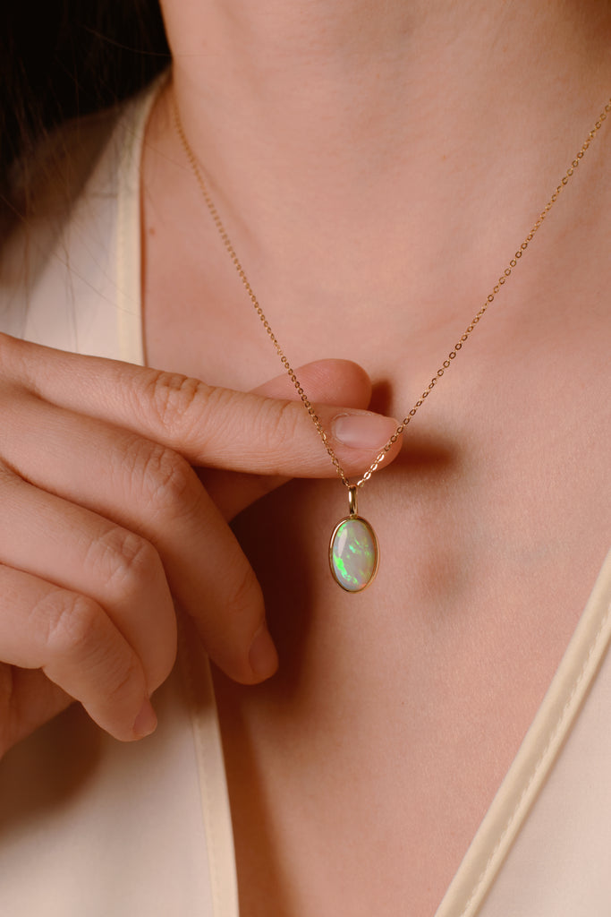 Model wearing Northern Lights Opal Necklace in Yellow Gold
