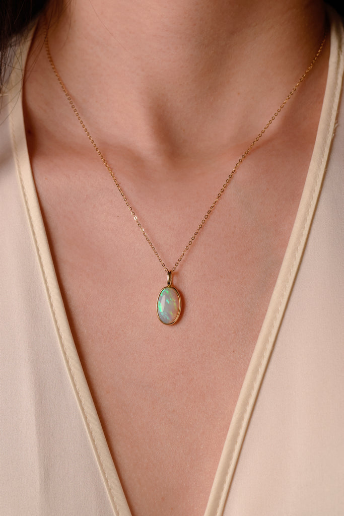 Model wearing Northern Lights Opal Necklace in Yellow Gold