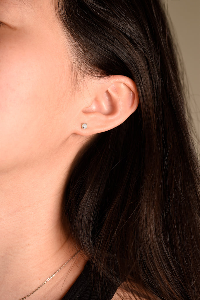 Model wearing Round Opal Stud Earrings in Sterling Silver, White