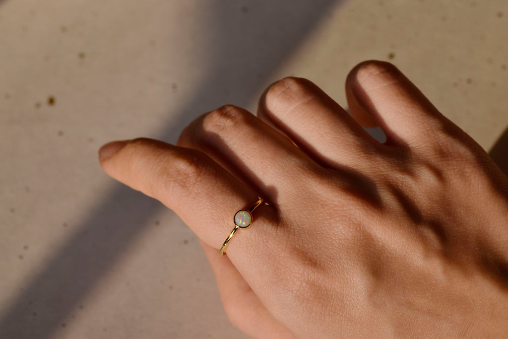 Model wearing Round White Opal Ring in Sterling Silver, Yellow Gold Plated
