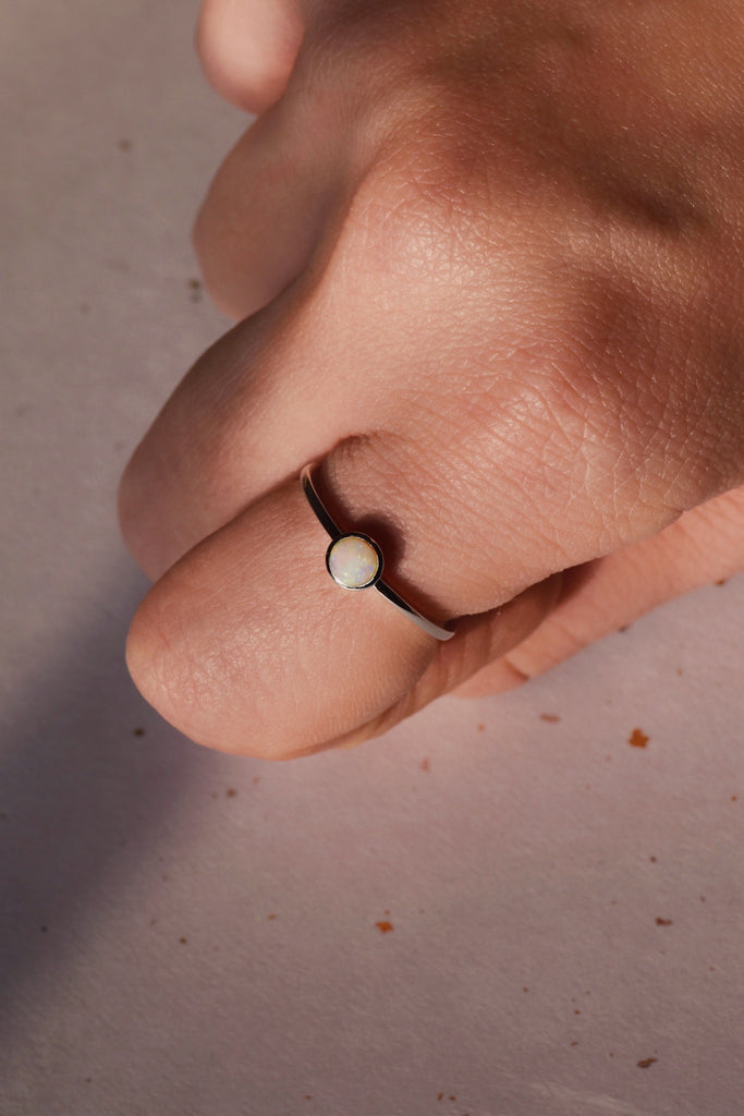 Model wearing Round White Opal Ring in Sterling Silver
