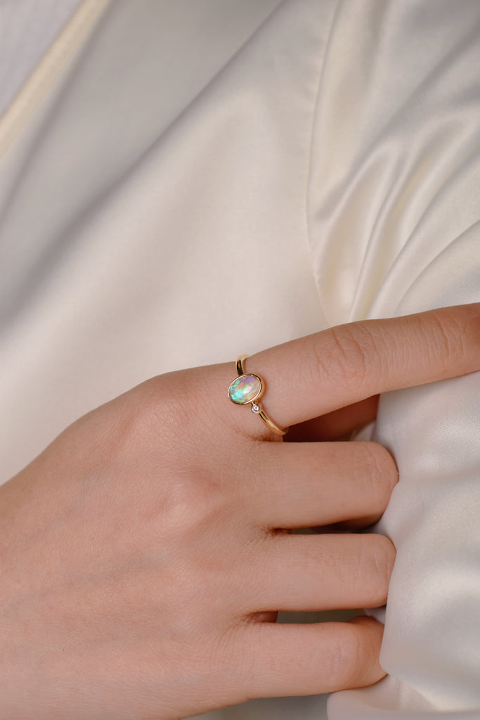 Model wearing Serenus Opal Ring with Diamond in Yellow Gold