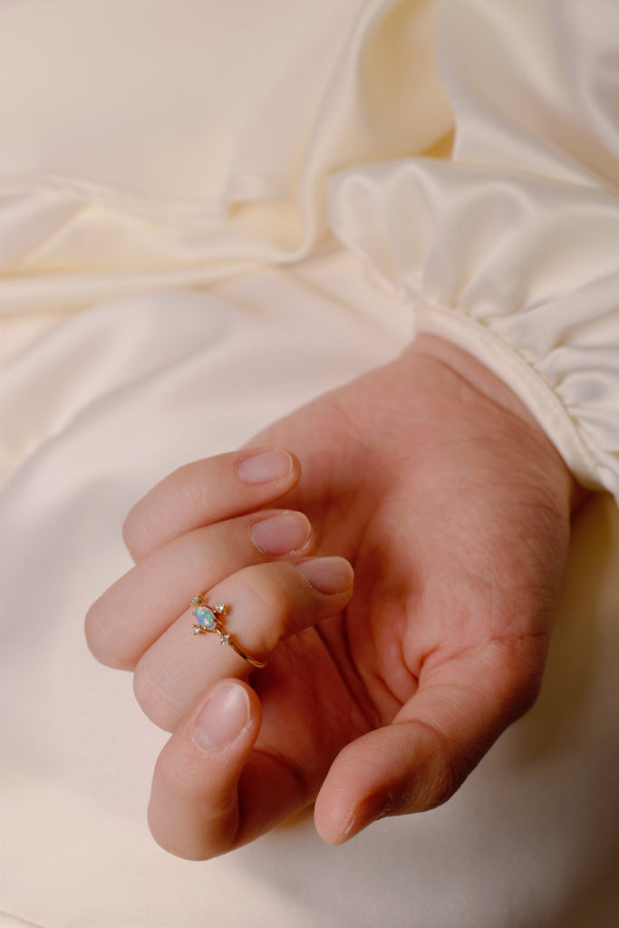 Model wearing Shimmering Opal Ring with Diamonds in Yellow Gold