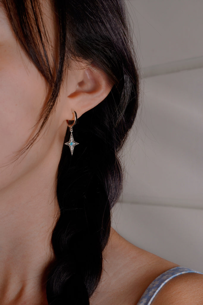 Model wearing The Star of Bethlehem Opal Hoop Earrings in Sterling Silver