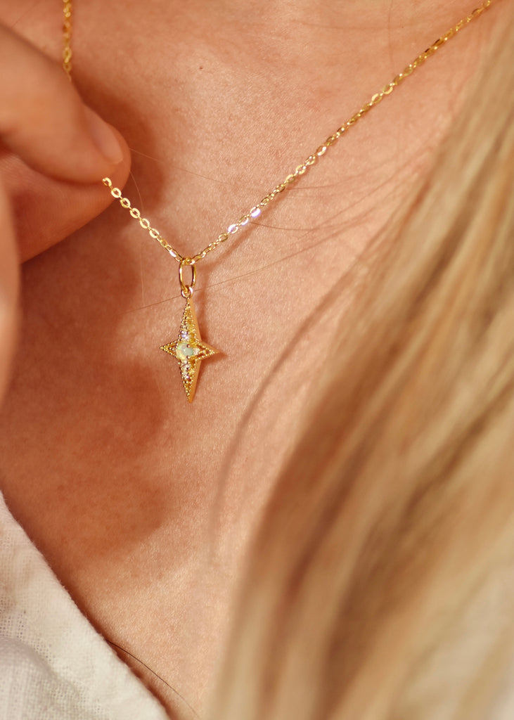 Model wearing The Star of Bethlehem Opal Necklace in Sterling Silver, Yellow Gold Plated.