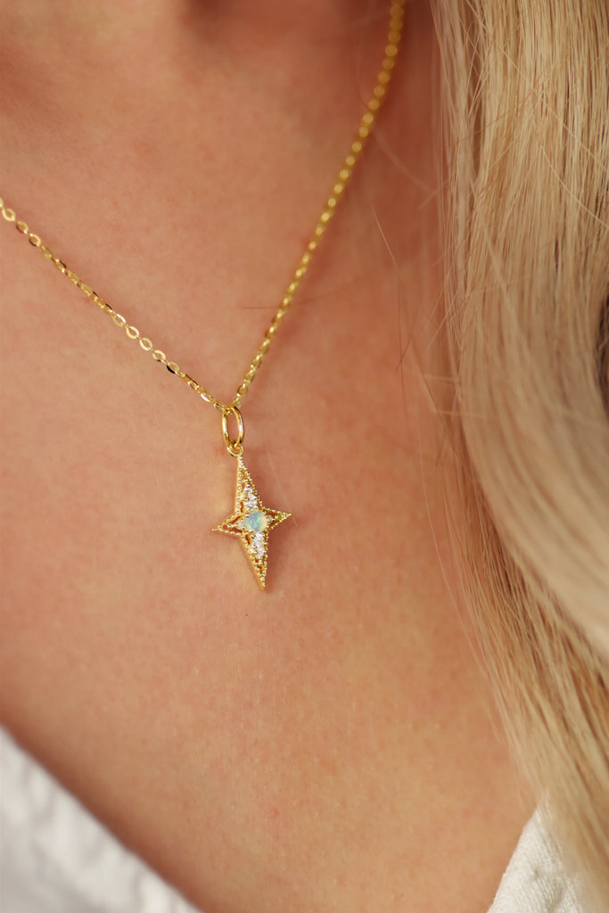 Model wearing The Star of Bethlehem Opal Necklace in yellow-gold-plated sterling silver.
