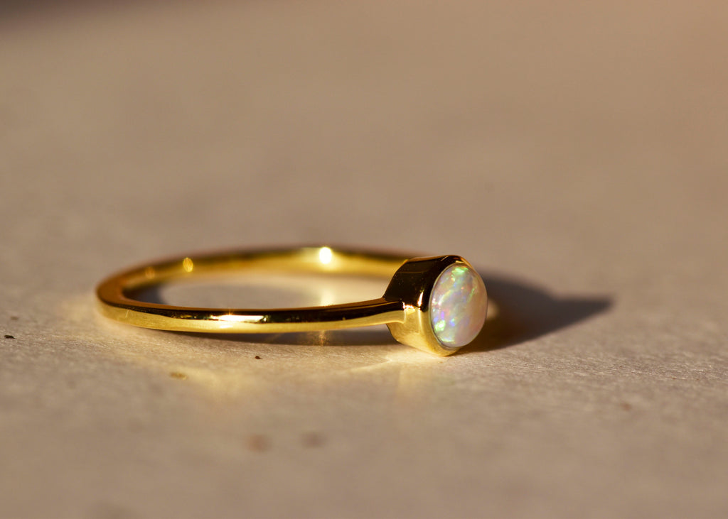 Round White Opal Ring in Sterling Silver, Yellow Gold Plated - Mood Shot